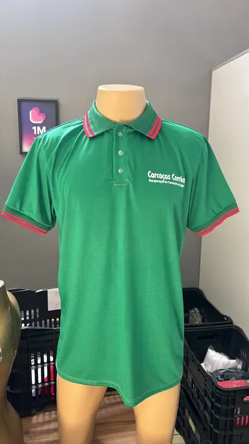 Polo verde com gola listrada e a marca Carcaças Corrêa